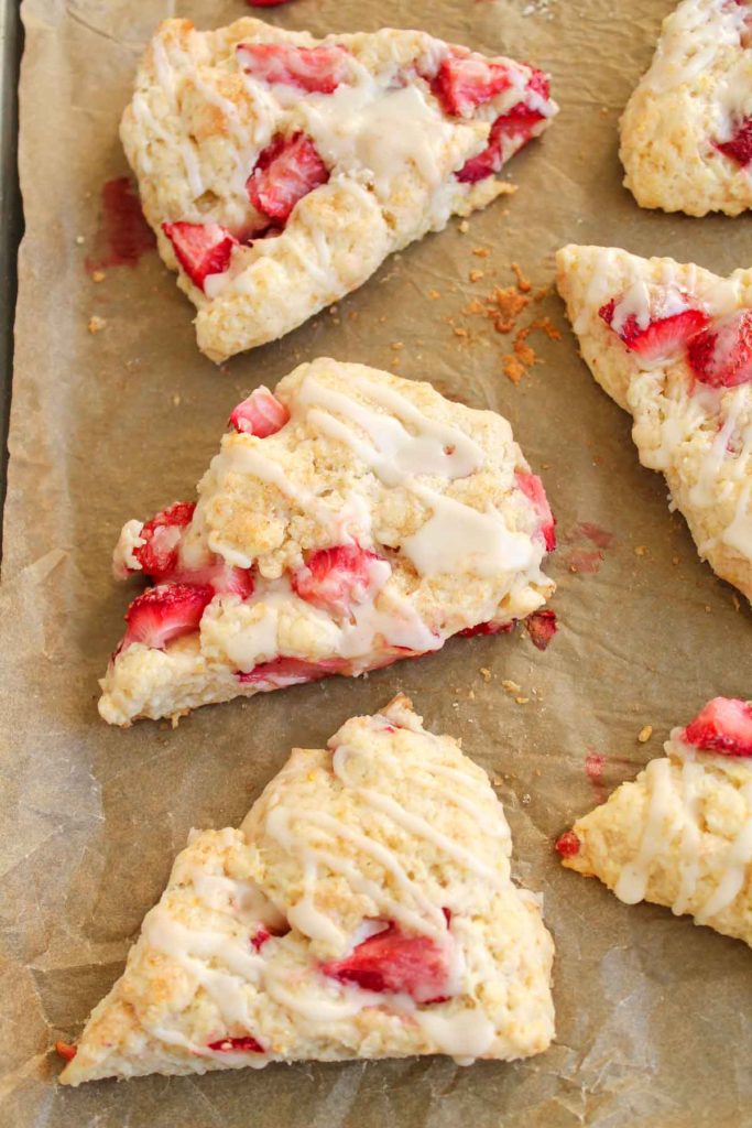 Baked scones on a parchment-lined baking sheet