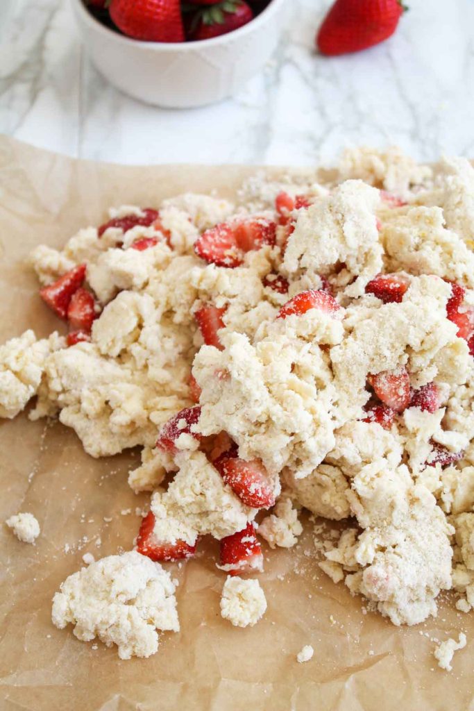 Strawberry Scone dough turned out of the bowl onto parchment-covered surface