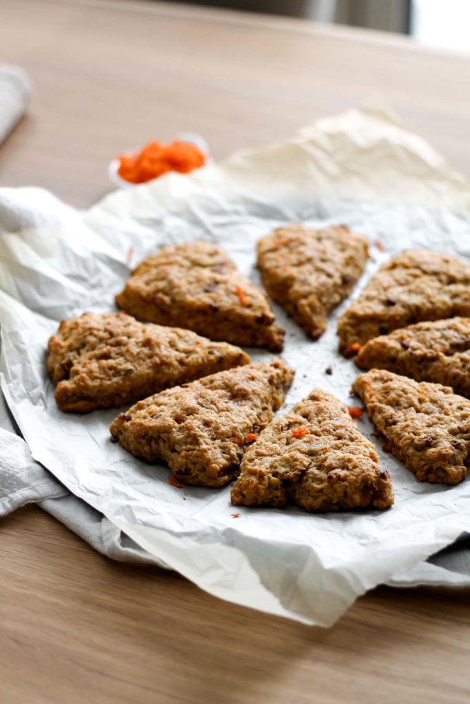 baked carrot scones arranged in a circle on parchment paper