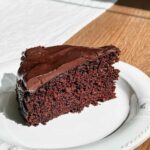 A slice of single layer chocolate cake with chocolate ganache