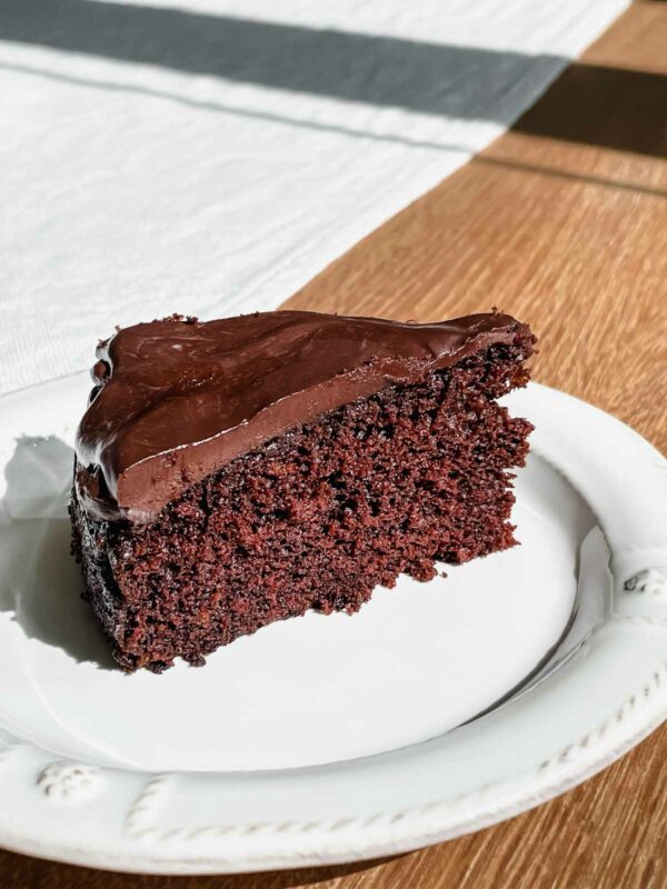A slice of single layer chocolate cake with chocolate ganache