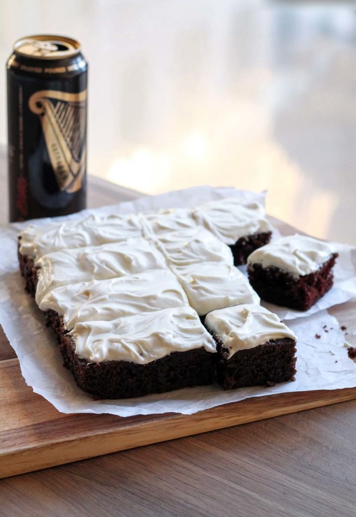 Slices of Single Layer Guinness Cake with Irish Cream Frosting with a can of guinness in the background