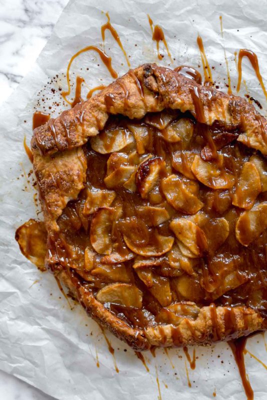 Baked apple galette with salted caramel sauce drizzled over top