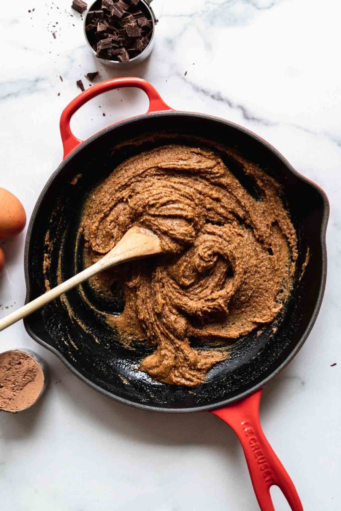 recipe in process: Almond butter, sugar, and milk mixed together in an oven-safe skillet