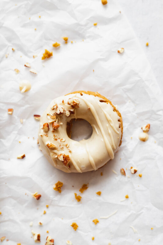 baked pumpkin donut with salted maple glaze and pecans
