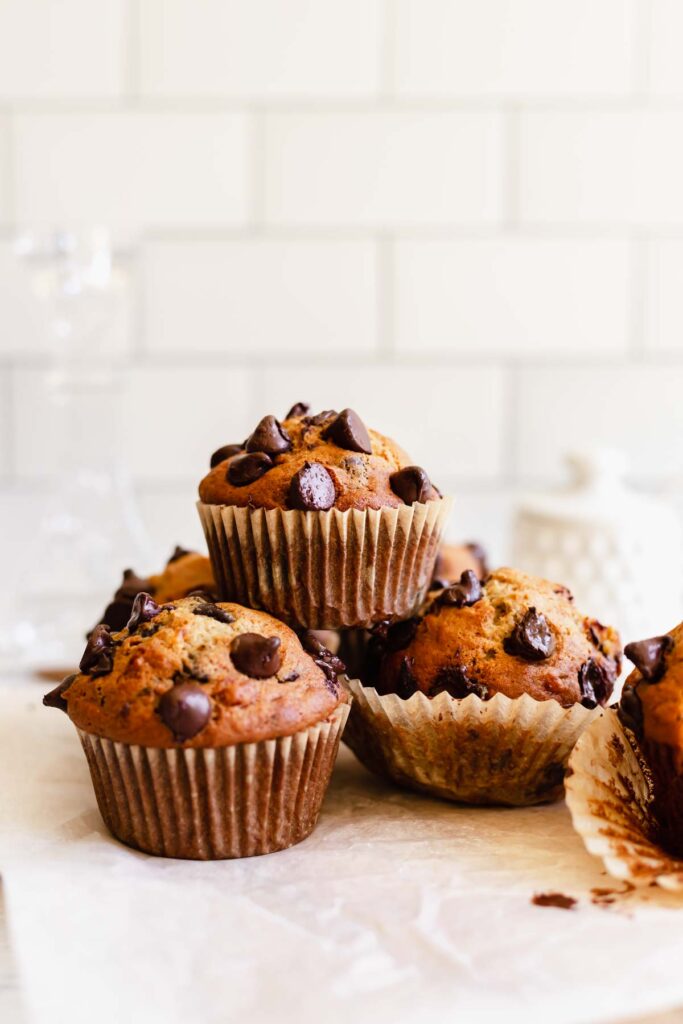 A few chocolate chip banana muffins stacked (small batch)