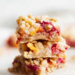 a stack of baked peach raspberry oatmeal crumble bars