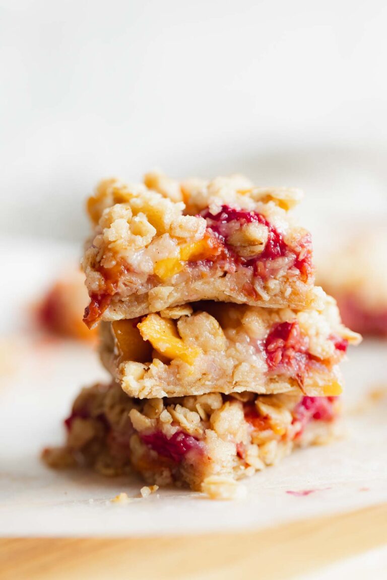 a stack of baked peach raspberry oatmeal crumble bars