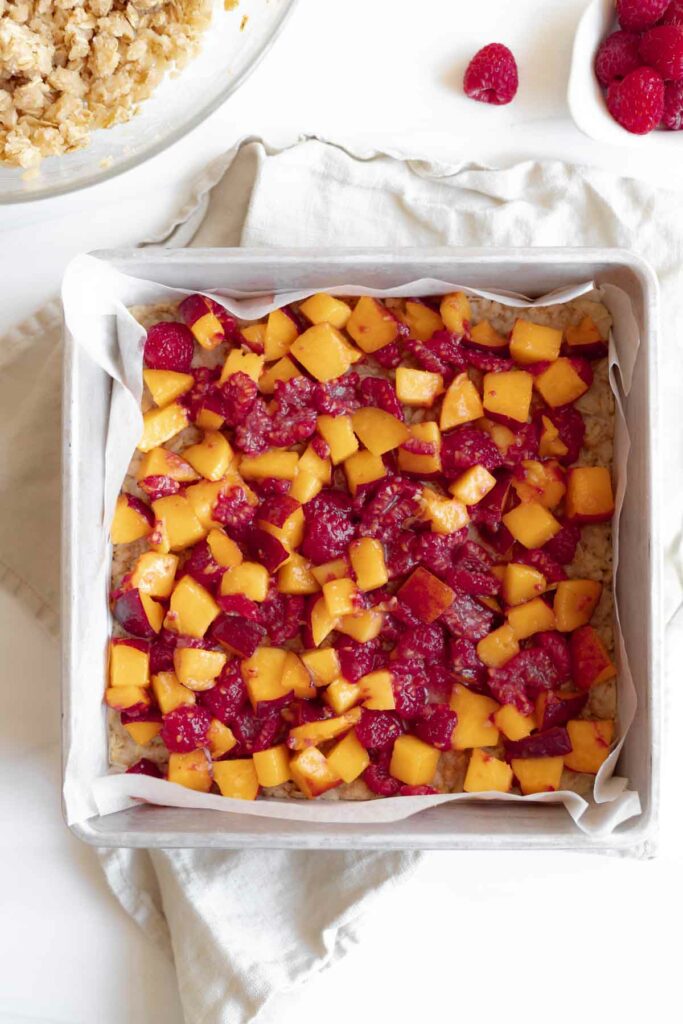 layer the peach raspberry filling on top of the crust
