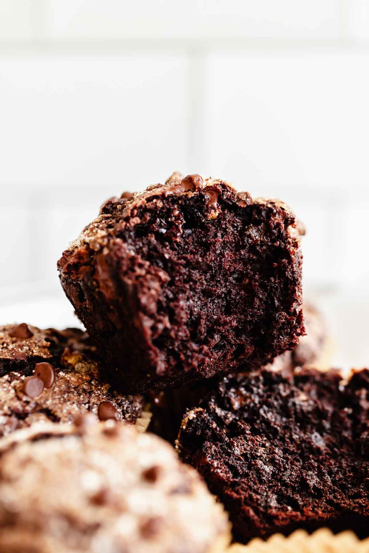 small batch double chocolate banana muffins - close up shot of a muffin with a bite taken out