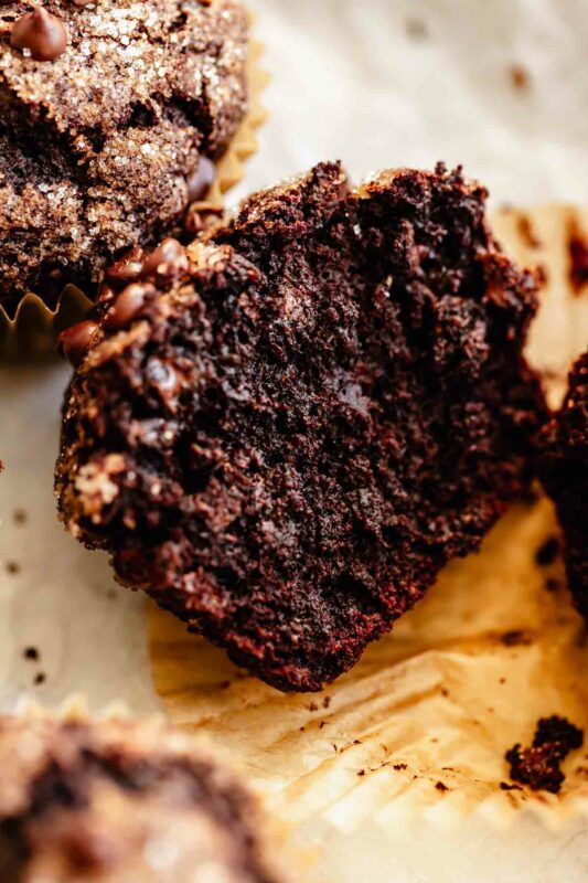 close up interior view of a chocolate chocolate banana muffin with chocolate chips - fudgy texture!