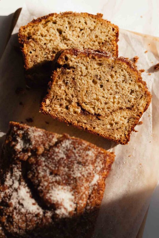 slices of cinnamon swirl banana bread layered on a cutting board