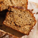 a piece of cinnamon swirl banana bread, just sliced and laying on a cutting board
