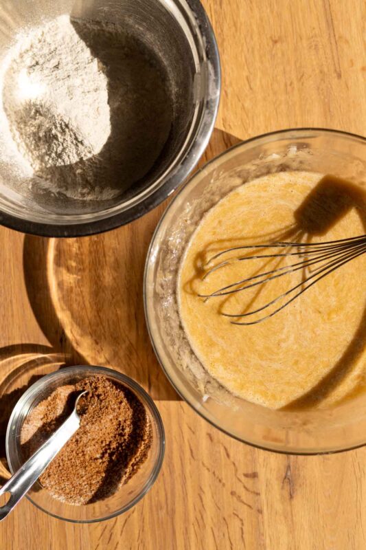 prep view: 3 bowls with wet ingredients and dry ingredients on a wooden surface