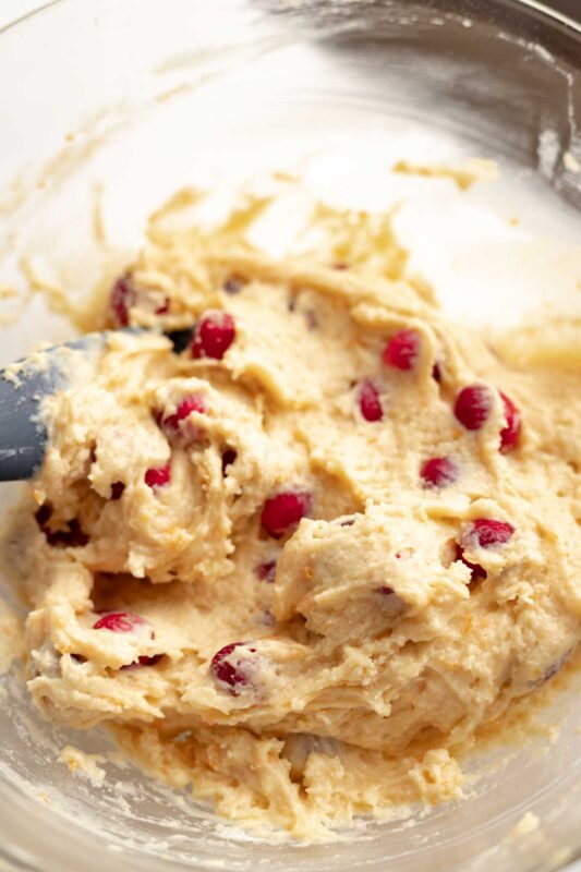 close up of cranberry orange muffin batter in a glass bowl
