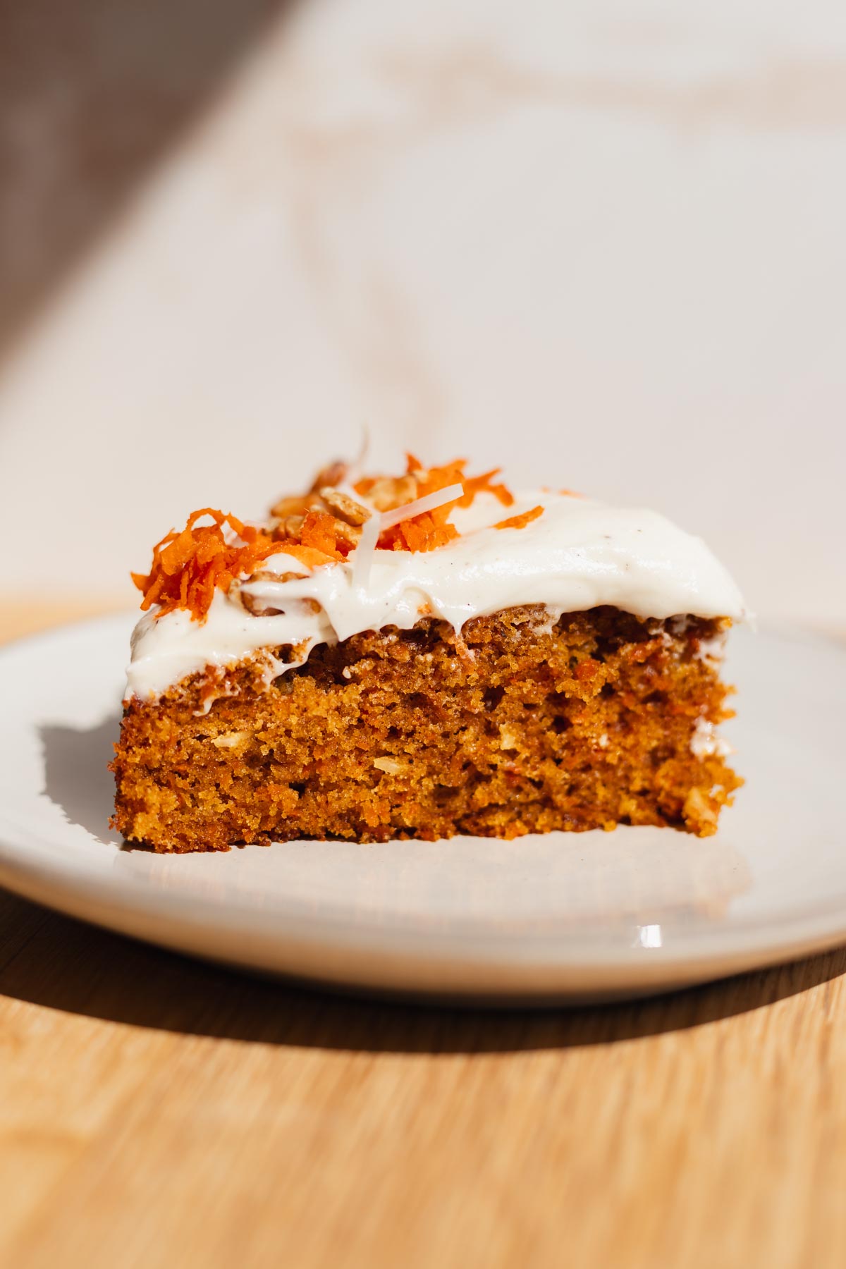 cross section slice of carrot cake - taller because it was baked in an 8" round cake pan instead of 9"